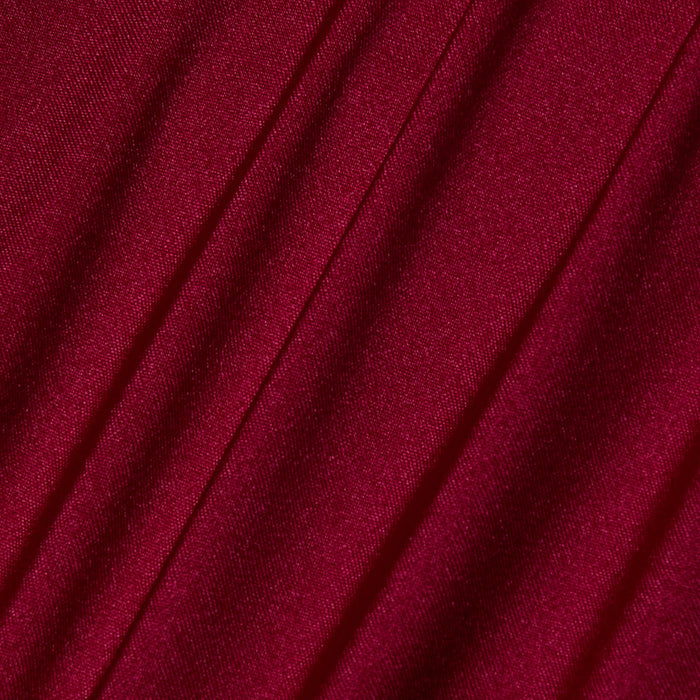Close-up of deep red, black cherry fabric with diagonal pleats and a smooth, slightly shiny texture on the Nicole Bikini Bottom.