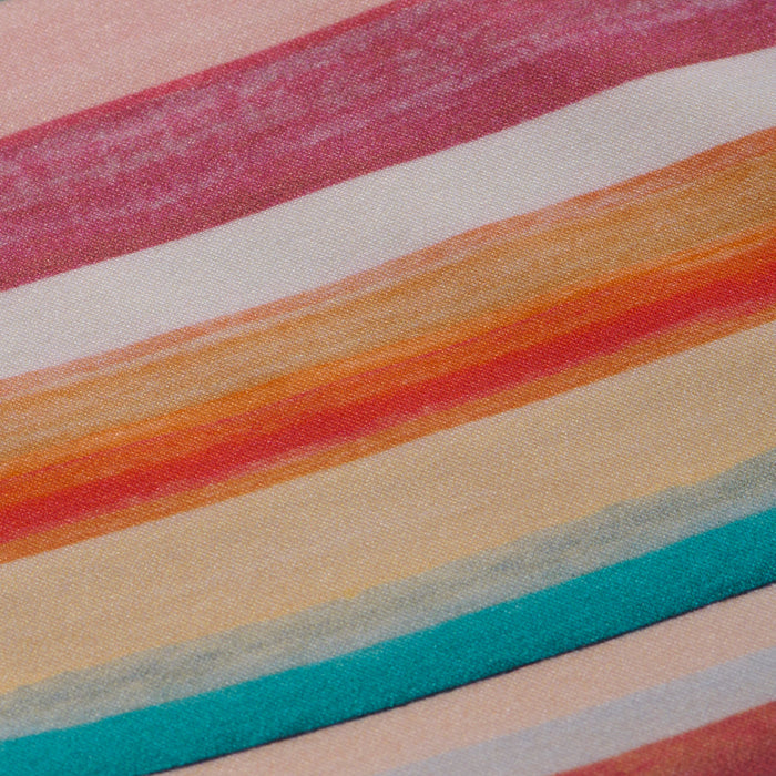 Close-up of the Nicole Bikini Bottom’s fabric showcasing horizontal retro watercolor stripes in shades of pink, red, orange, yellow, and blue. The four-way stretch nylon features stripes of varying widths with a soft, textured look.