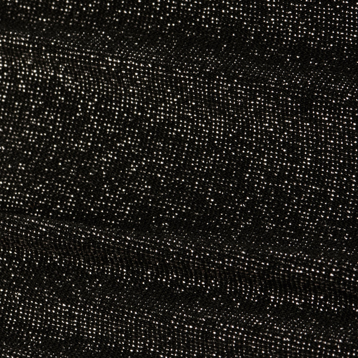 Close-up of the Nicole Bikini Bottom’s textured metallic black fabric, featuring small white specks evenly distributed across the surface for a starry, glittery effect.