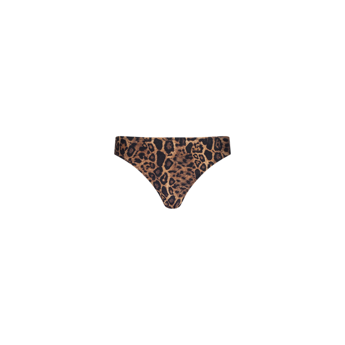 The Nicole Bikini Bottom features a leopard print design with a high-cut leg, crafted from four-way stretch nylon to provide a comfortable fit and moderate coverage, shown against a plain white background.