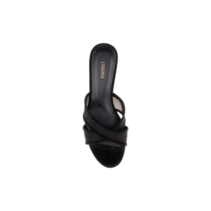A single Padua Mesh Sandal in black suede with overlapping straps and “L’AGENCE” inscribed on the insole is displayed from a top-down view against a white background.