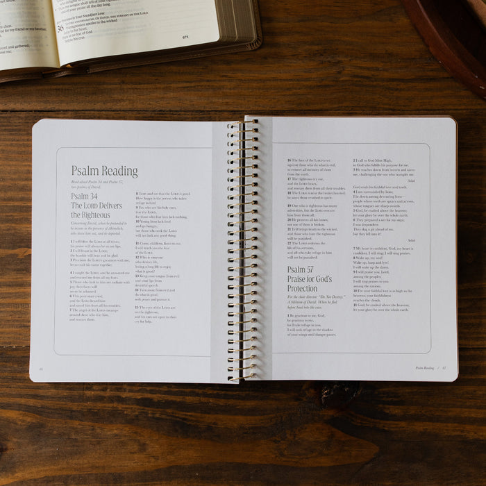 Peaks and Valleys Spiral Study opened to the Psalm Reading page next to a dark brown wooden tray and an open bible on a brown wooden table