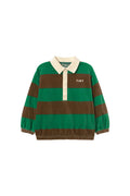 A green and brown horizontally striped long-sleeve rugby shirt with a cream collar and button placket, featuring the brand name 'TINY' on the chest, shot against a solid off-white background.
