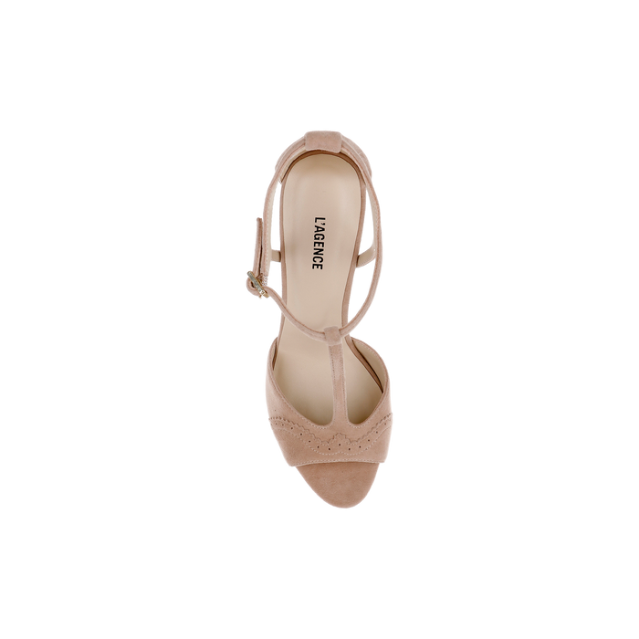 Top view of a single Radha Suede Sandal in cappuccino suede with brogue detailing, T-strap, and ankle buckle, featuring the brand name LA GENEE printed on the insole, displayed on a plain white background.