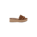 The Ramani Platform Espadrille is a single flat platform slide sandal featuring a brown and black leopard print suede strap and a braided jute sole, shown from the side on a white background—perfect for effortless summer style.