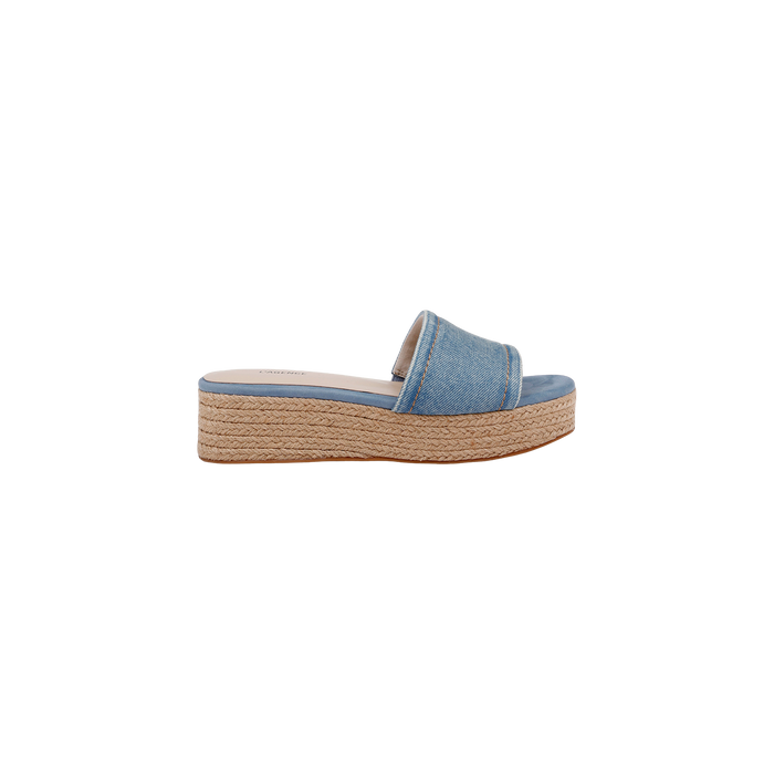 The Ramani Platform Espadrille features a blue denim upper and a thick jute platform sole, capturing the essence of classic platform espadrille design. Shown in a side view against a plain white background, this sandal is perfect for warm-weather style.