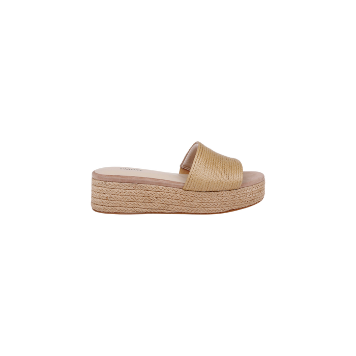 The Ramani Platform Espadrille is a tan slide sandal showcasing a raffia upper and a thick, braided straw platform sole, pictured in profile against a plain white background—an ideal pick for warm-weather style.