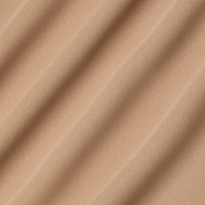Close-up of beige poly georgette fabric with soft, diagonal waves and shadows, highlighting its smooth texture and gentle folds—an ideal choice for the Raye Slip Lining Dress featuring adjustable straps.