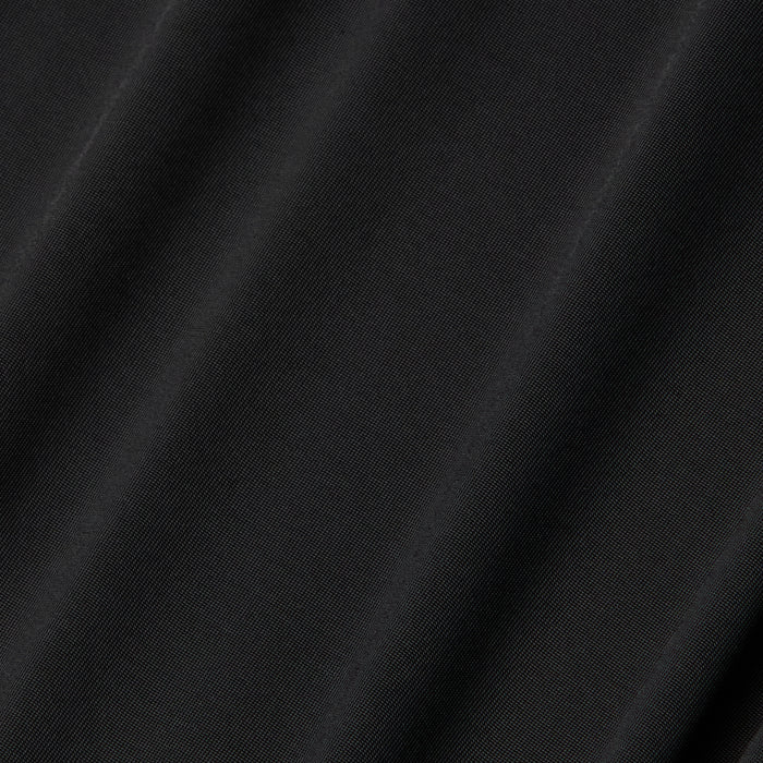 Close-up of the Raye Slip Lining Dress in black poly georgette fabric, featuring subtle diagonal folds that highlight its smooth texture and slight sheen under the light.