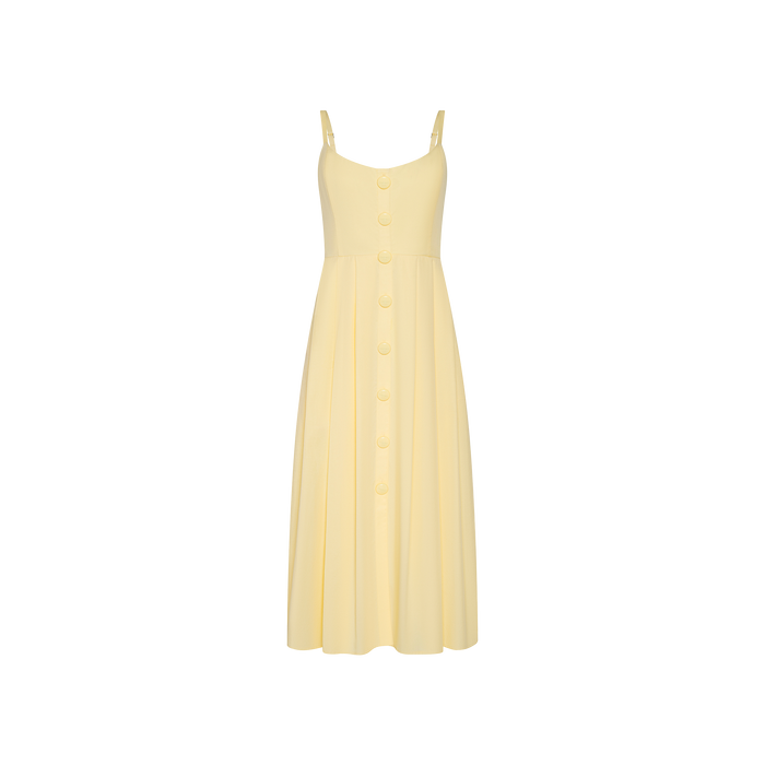 Introducing the Reanne Midi Dress: a light yellow poplin dress featuring spaghetti straps, a V-neckline, and oversized front-center buttons. The gently pleated skirt creates a soft, feminine silhouette, while the smocked back ensures flexible comfort.