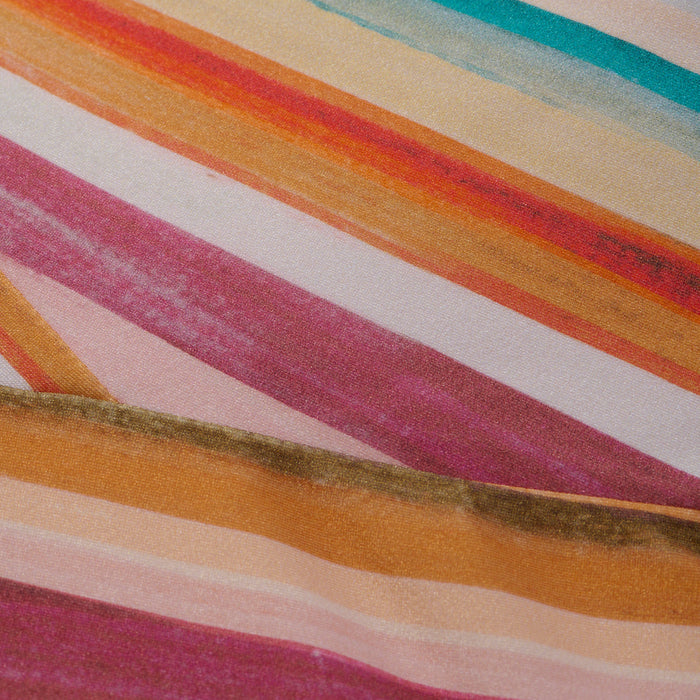 A close-up of the Remi One-Piece Swimsuit shows diagonal watercolor stripes in pink, orange, yellow, green, and white, forming a vibrant abstract pattern.