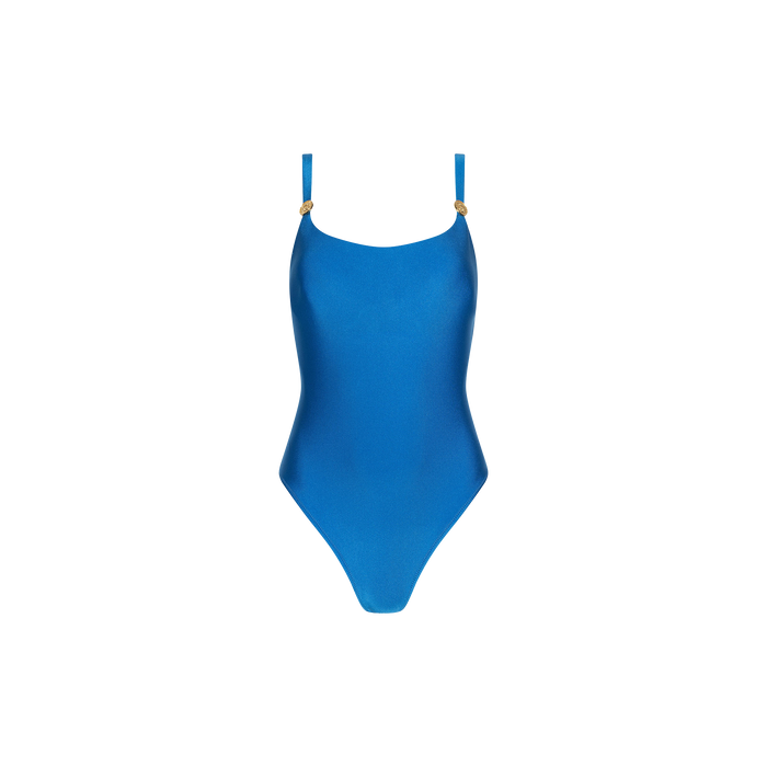 The Remi One-Piece Swimsuit features a vibrant blue hue, thin adjustable straps, gold ring accents at the front, and a flattering high-leg cut, shown against a plain white background.