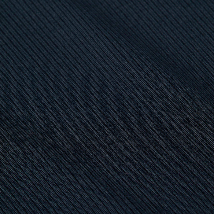 Close-up of the Ressi Micro-Rib Tee’s dark, ribbed microfiber fabric with diagonal textured lines, featuring fine, detailed stitching and a soft material appearance.