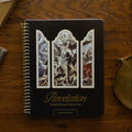 Revelation Spiral Study cover on a wooden table next to a bronze candlestick and some old books