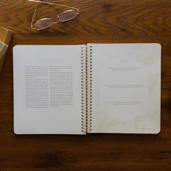 Revelation Spiral Study opened to page 108, Questions and Applications page, on a wooden table next to a pair of glasses