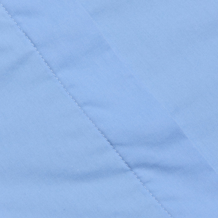 Close-up of light blue fabric with a diagonal seam and visible stitching detail, showcasing the smooth texture that makes it ideal for the Rina Poplin Halter Top.