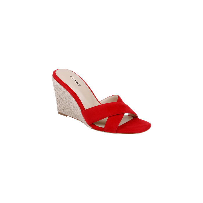 The Rosaline Wedge Espadrille is a red suede sandal with crisscross straps and a woven platform heel, featuring a memory foam insole for added comfort, shown against a plain white background.