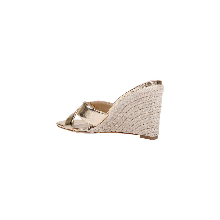 The Rosaline Wedge Espadrille is a gold leather sandal featuring an open toe, crisscross straps, a woven espadrille wedge heel, and a comfortable memory foam insole, displayed on a plain white background.