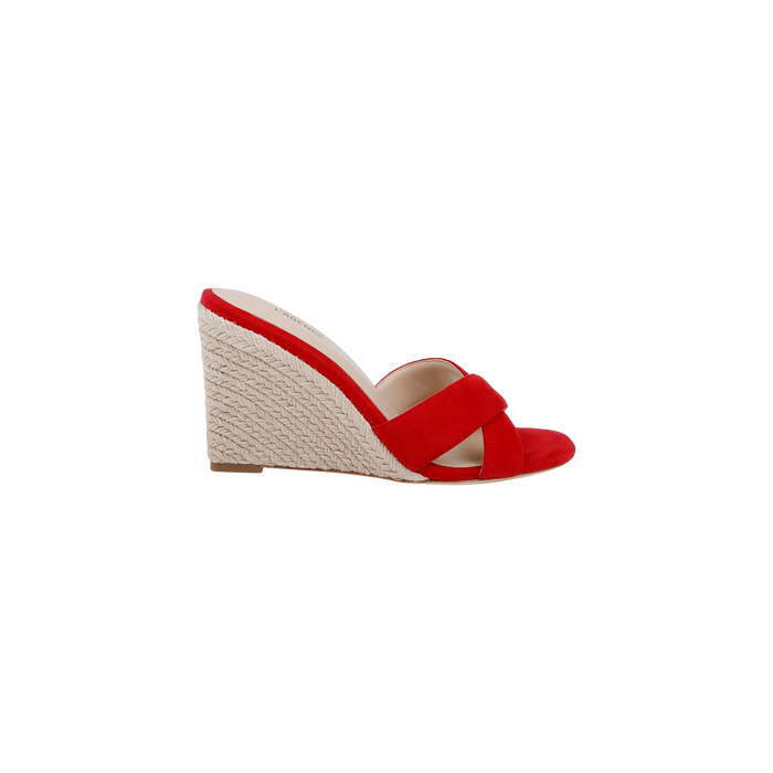The Rosaline Wedge Espadrille is a red suede open-toe sandal featuring crisscross straps and a textured light-colored wedge heel, showcased against a plain white background.