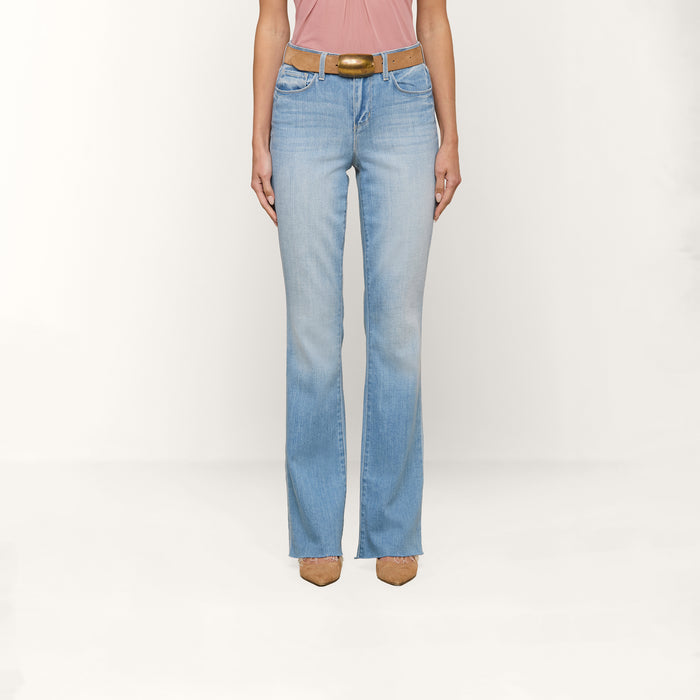 Person wearing Ruth Straight-Leg Jean in a light indigo wash with a brown belt, a pink sleeveless top, and tan pointed-toe shoes, standing against a plain white background. Only the upper legs down to the feet are visible.