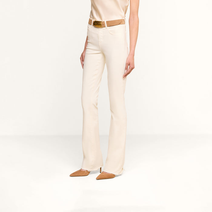 A person wearing Ruth Straight-Leg Jean in a cream shade, paired with a beige sleeveless top, a brown belt, and brown pointed-toe shoes stands against a plain white background.