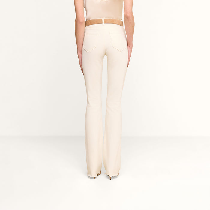 Person wearing Ruth Straight-Leg Jean in vintage white with a tan belt, standing against a plain white background, shown from the back.
