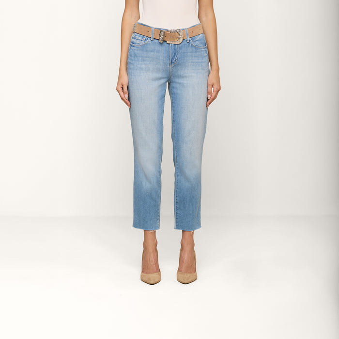 A person is shown from the shoulders down wearing the Sada Cropped Slim-Leg Jean in a light wash, styled with a tan belt, a white top, and beige heels against a plain white background.