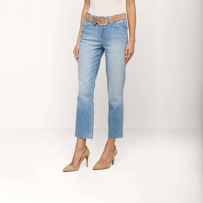 A person wearing the Sada Cropped Slim-Leg Jean, styled with a tan belt and tan high-heeled shoes, stands against a plain white background. Only the lower half of their body is visible.