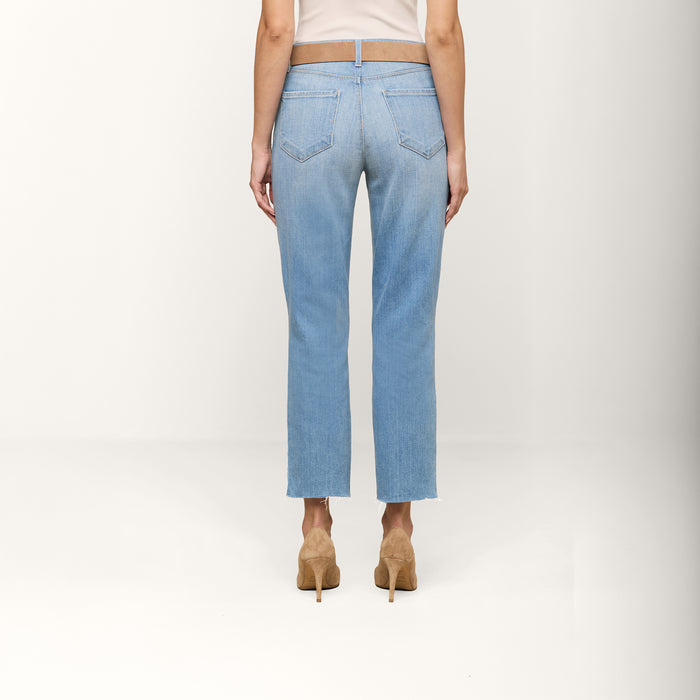 A person is shown from the back, wearing Sada Cropped Slim-Leg Jeans in a light wash and tan high-heeled shoes, against a plain white background.