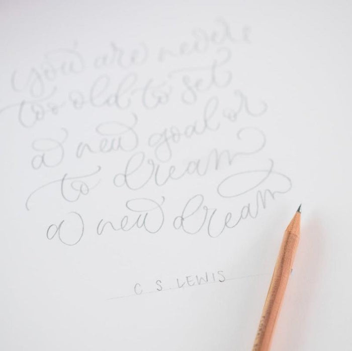 Cursive writing in pencil on cartridge paper with a scented pencil