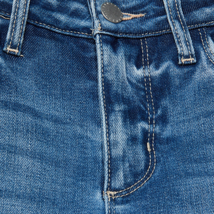 Close-up of the Scottie Wide-Leg Jean in blue denim, highlighting the waistband, button, zipper, belt loops, and detailed stitching. The fabric features slight fading and a textured appearance characteristic of well-worn stretch denim.