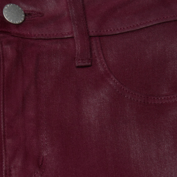 Close-up of the Selma Coated Bootcut Jean in maroon shows a pocket, belt loop, and metallic button. The coated denim’s texture and stitching details are highlighted in this high-rise baby bootcut style.