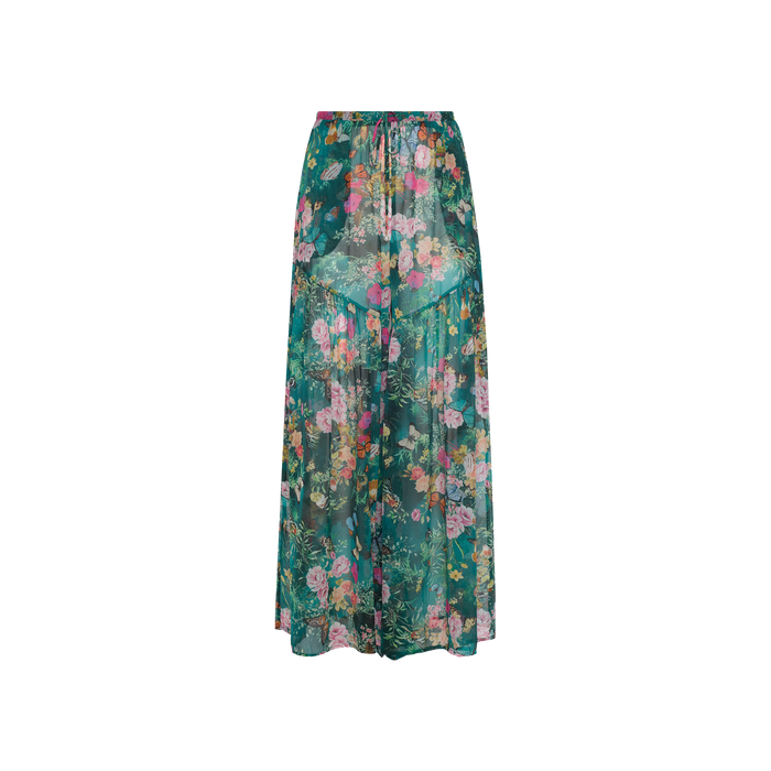 The Sharon Cover-Up Pant features a green base adorned with a vibrant floral print in shades of pink, yellow, and orange. Lightweight and perfect for beachwear, these flowy pants offer a gathered waistband resembling a drawstring for extra comfort.
