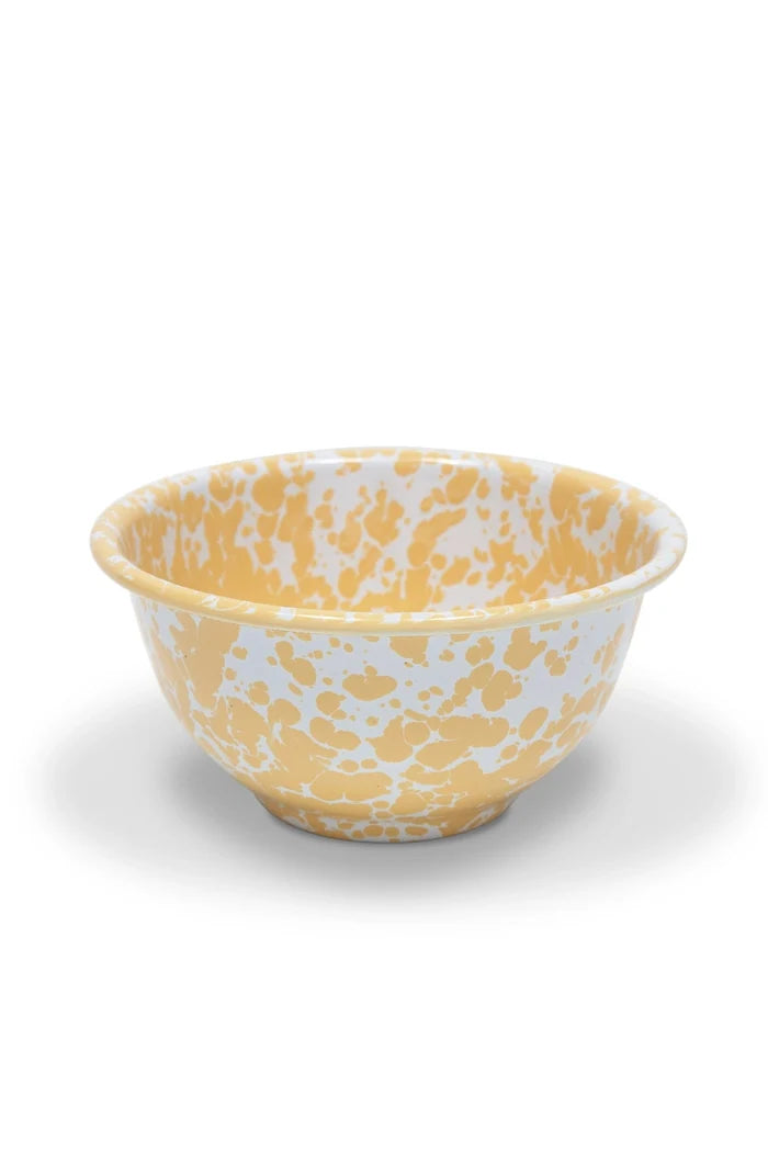Yellow and white enamelware bowl on a white background