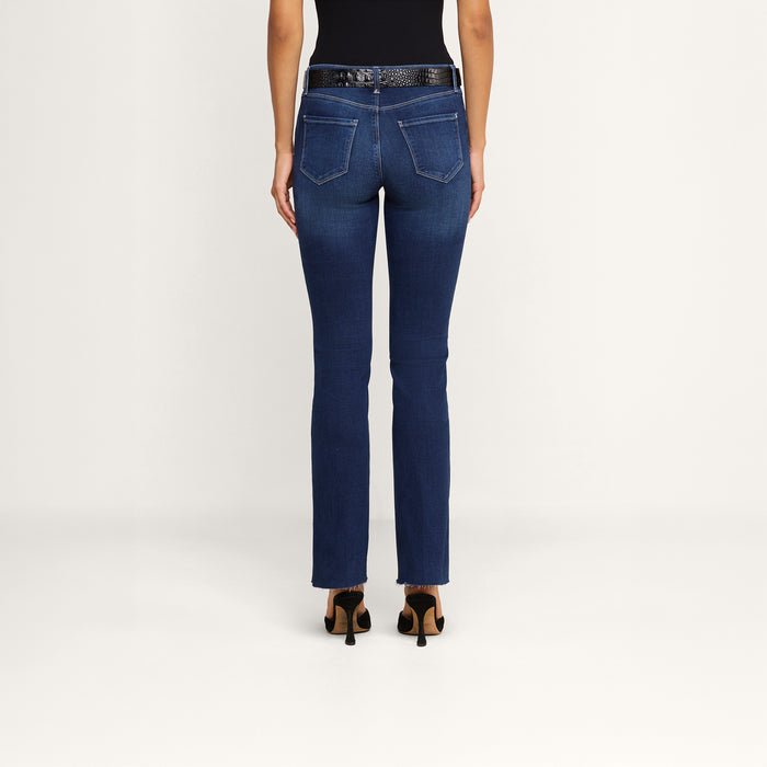 A person stands facing away, wearing a black sleeveless top, a pair of Sneeki Low-Rise Straight-Leg Jeans in dark wash super stretch denim with back pockets, a black belt, and black heeled shoes against a plain white background.