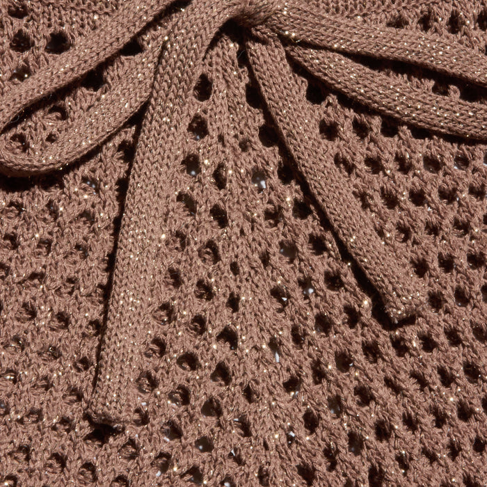 Close-up of the Solan Pointelle Knit Short in brown, featuring a glittery, net-like pointelle knit with shimmering threads woven throughout and a matching bow tied at the top center.