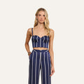 Wearing the Sonya Bustier and matching high-waisted pants with white vertical stripes, a woman with long blonde hair stands against a plain light background.