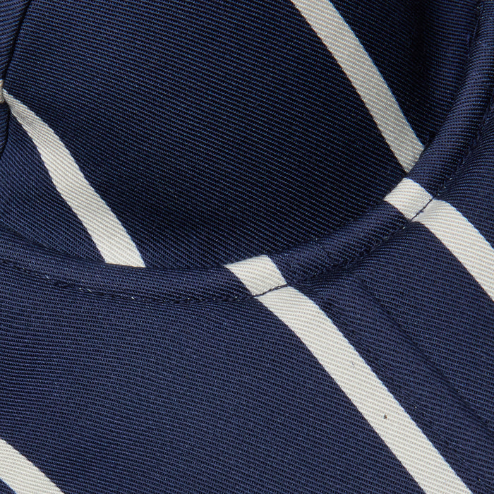 Close-up of the Sonya Bustier in navy, featuring white diagonal stripes and visible stitching, likely part of a garment or piece of clothing.