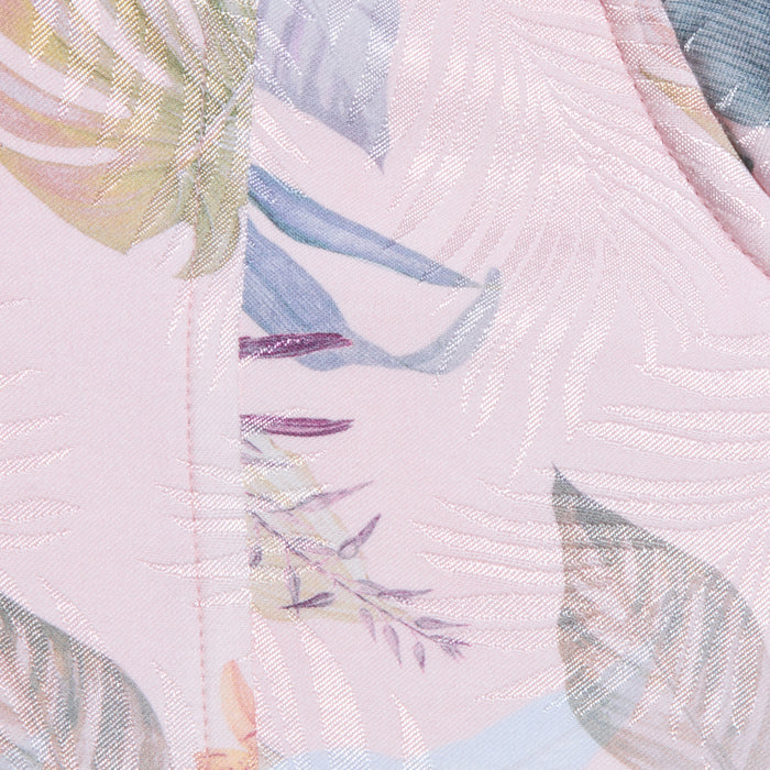 Close-up of the Sonya Bustier’s lightweight twill fabric featuring a shiny, textured palm leaf print and soft, multicolored tropical leaf designs in blue, yellow, and purple tones.