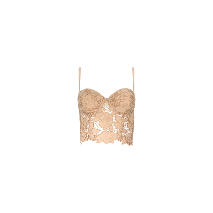 The Sonya Bustier, a beige lace crop top featuring floral patterns and thin adjustable straps in a bustier style, is displayed on a plain white background.