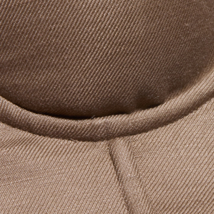 Close-up of the brown, textured fabric of the Sonya Linen-Blend Bustier, showcasing visible stitching and a curved seam.