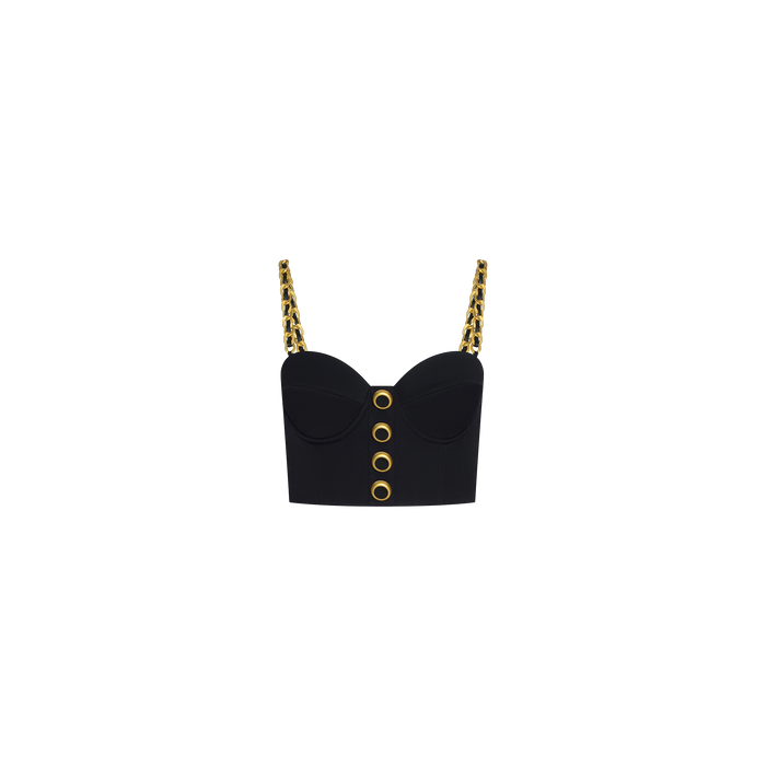 A black cropped bustier called the Sophia Chain Bralette, featuring a structured silhouette with gold chain straps and large gold grommet details down the front, crafted from stretch suiting fabric and displayed on a plain white background.