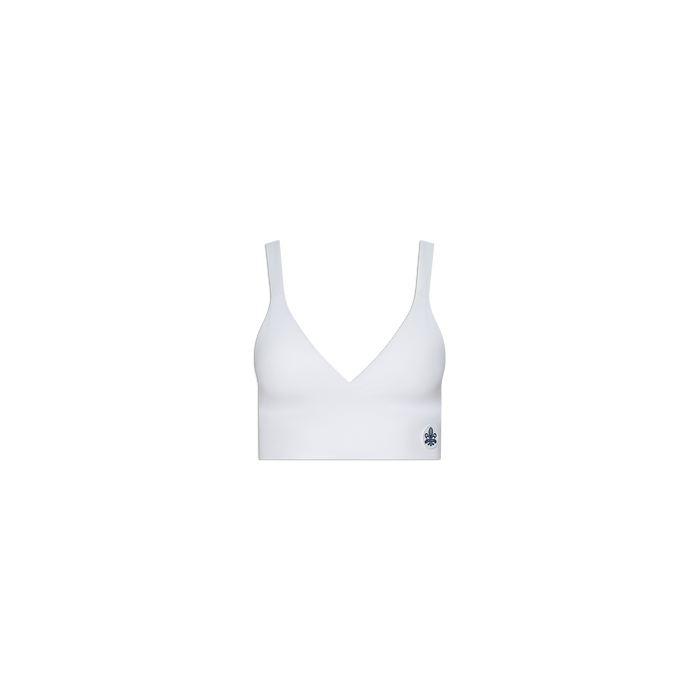 Steffi Tennis Bralette in white, showcasing a deep V-neckline and wide straps, with a subtle dark floral logo on the lower left band—displayed against a plain white background.