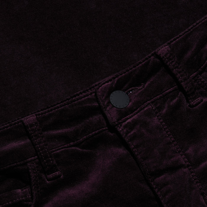 Close-up of the Stevie Velvet Jean, crafted from a soft, dark-colored velvety fabric, featuring a high-rise waistband, stitched belt loops, and a black front button.