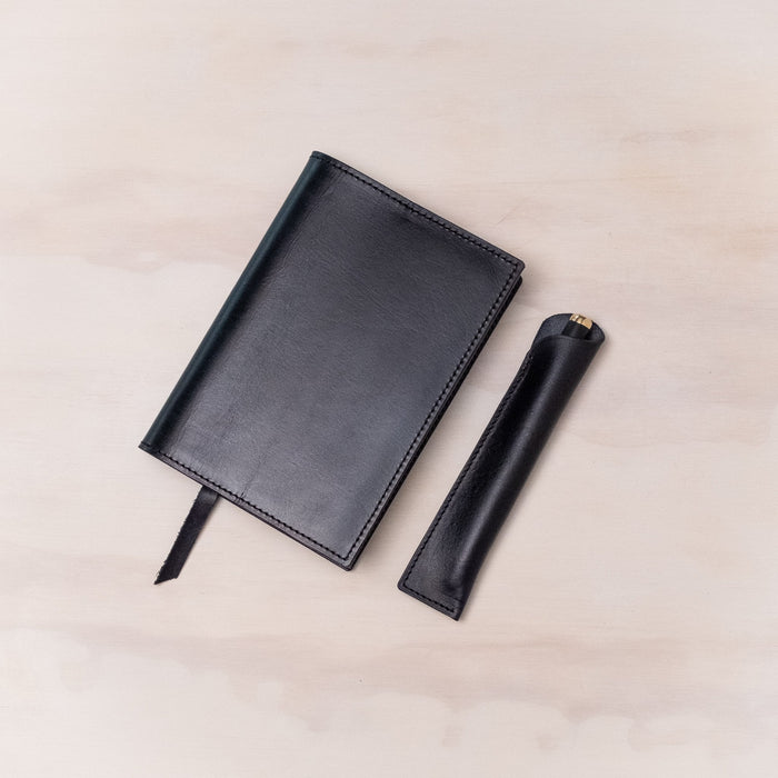 Leather Pen Sleeve for the Lumos Pro in Black shown with matching leather notebook cover and the Studio Fountain Pen in Black