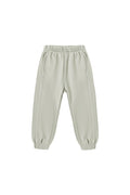 A pair of light sage green jogger pants with an elastic waistband and elastic cuffs, shown flat on a white background.