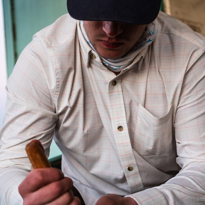 man shucking oysters in The Apalachicola shirt