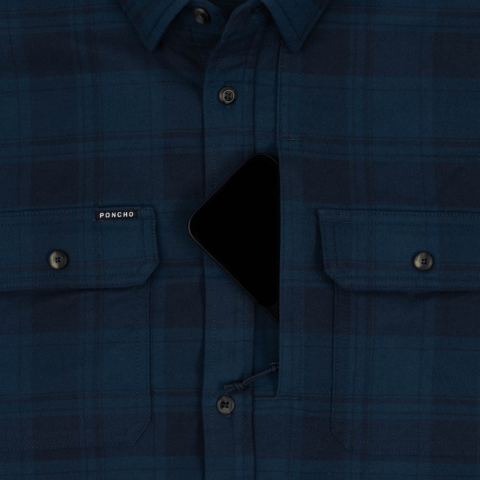 Close-up of The Blue Goose shirt in blue plaid with buttoned chest pockets and a hidden zipper pocket in the center.