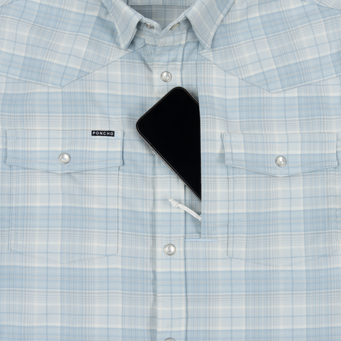 Light blue plaid shirt with black smartphone partially tucked inside the front pocket