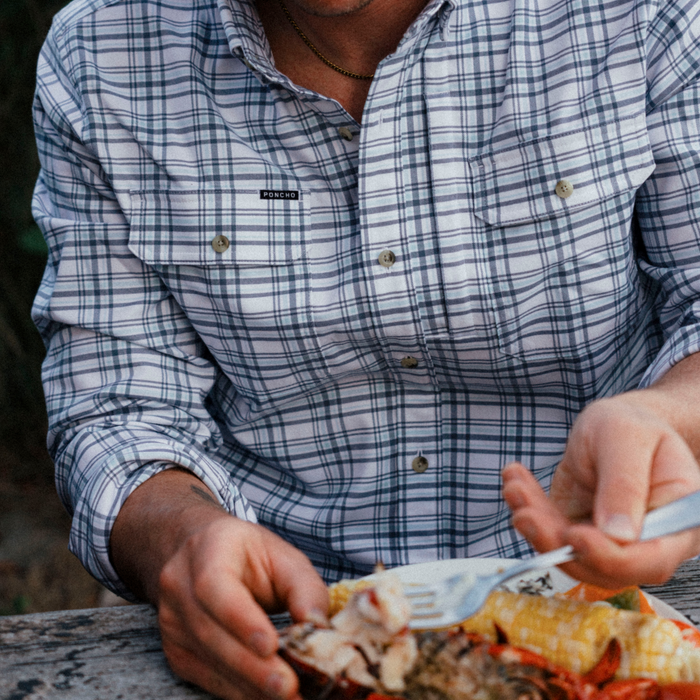 The Fog Horn plaid shirt worn outdoors while enjoying a grilled seafood meal at a picnic table